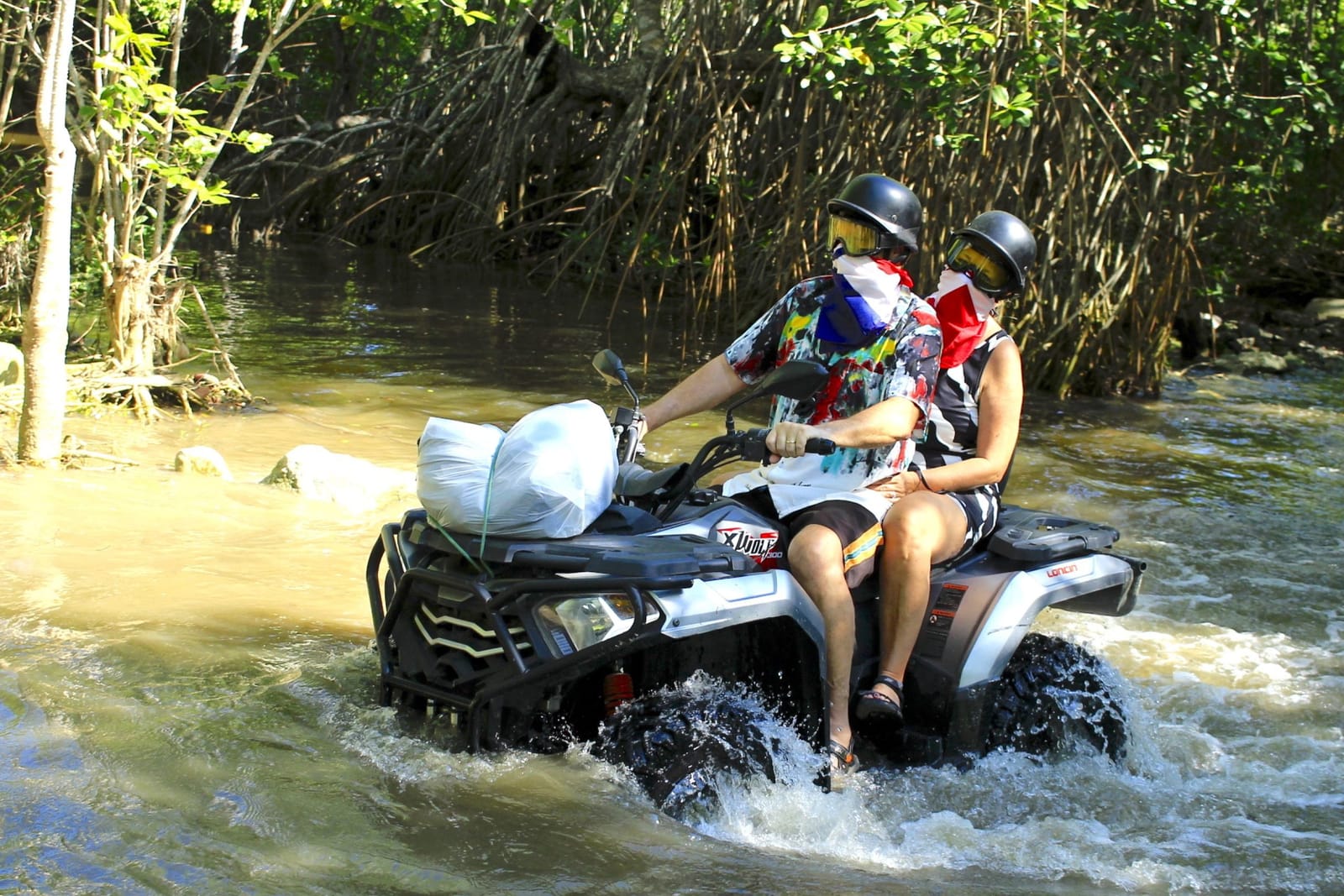 Two travelers sharing an ATV on a Puerto Plata trail
